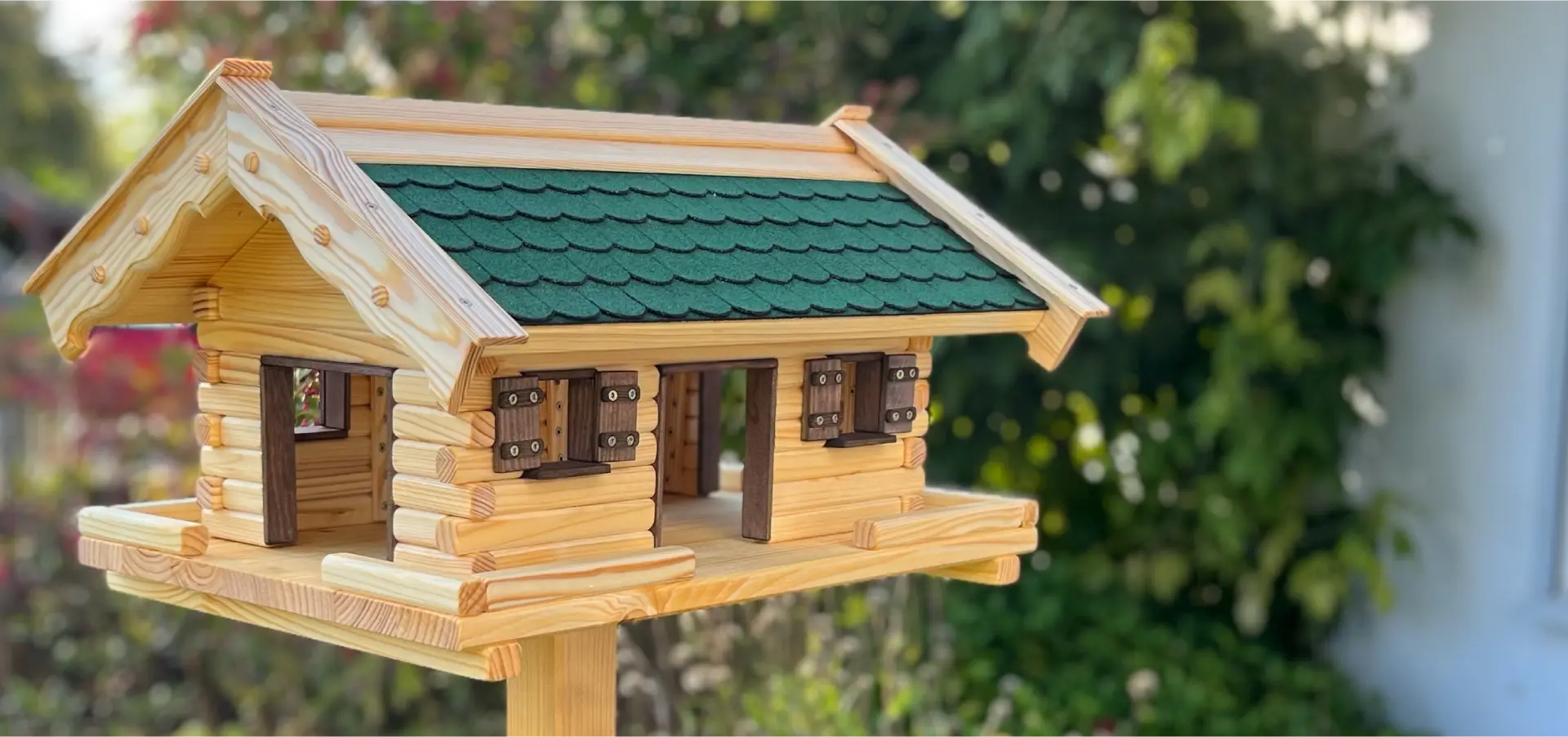 Handgefertigtes Vogelhaus aus Holz im Garten